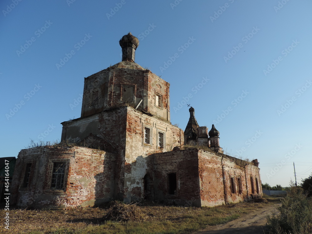 The building of an abandoned church, made of red brick, with characteristic features of the Baroque era.
