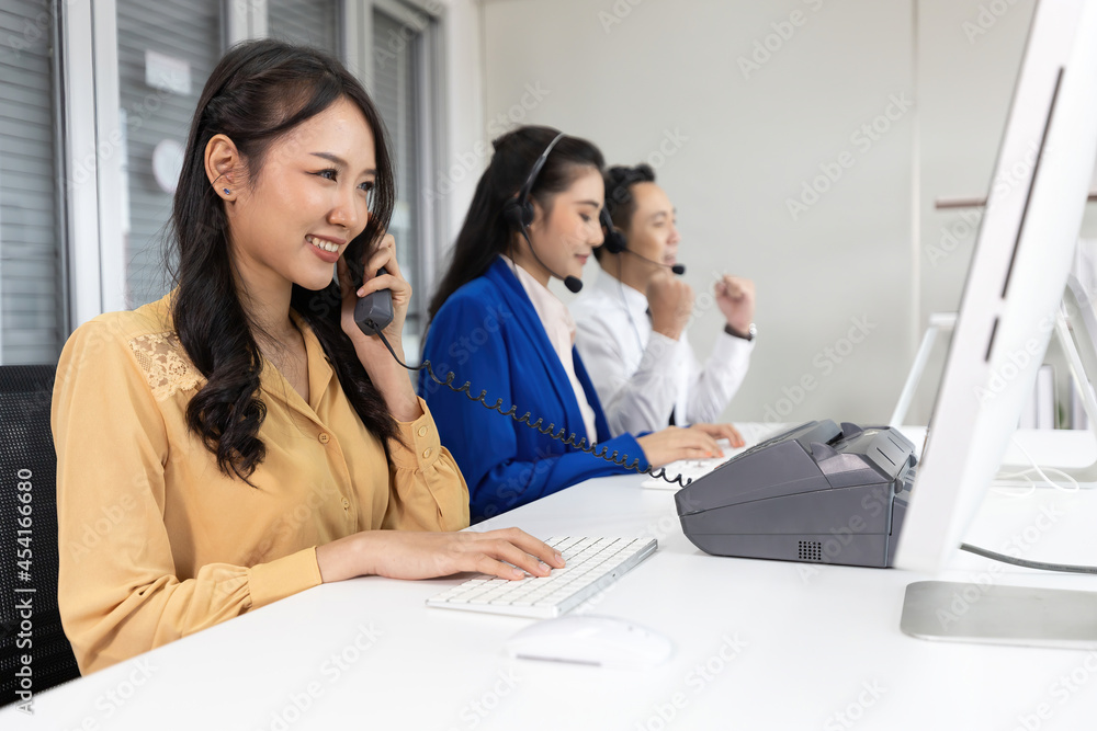 woman operator pick up telephone and talking with customer at call center service woman operator pick up telephone and talking with customer at call center service