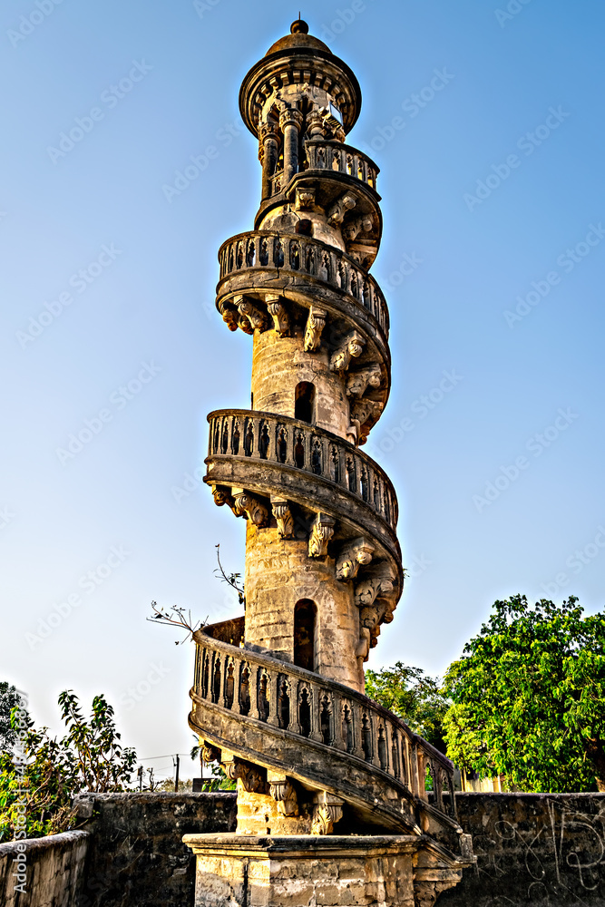 Spiral staircase around ancient stone pillar at Mohabbat Maqbara