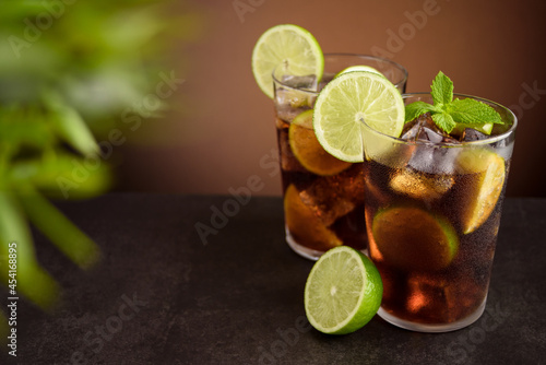 Cuba Libre cocktail. Alcoholic drink with cola, rum, lime and mint. Cuba Libre or long island iced tea cocktail.