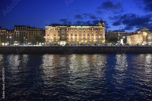 San Sebastian, Spain - 29 Aug 2021: Hotel Maria Cristina illuminated on the banks of the Urumea River