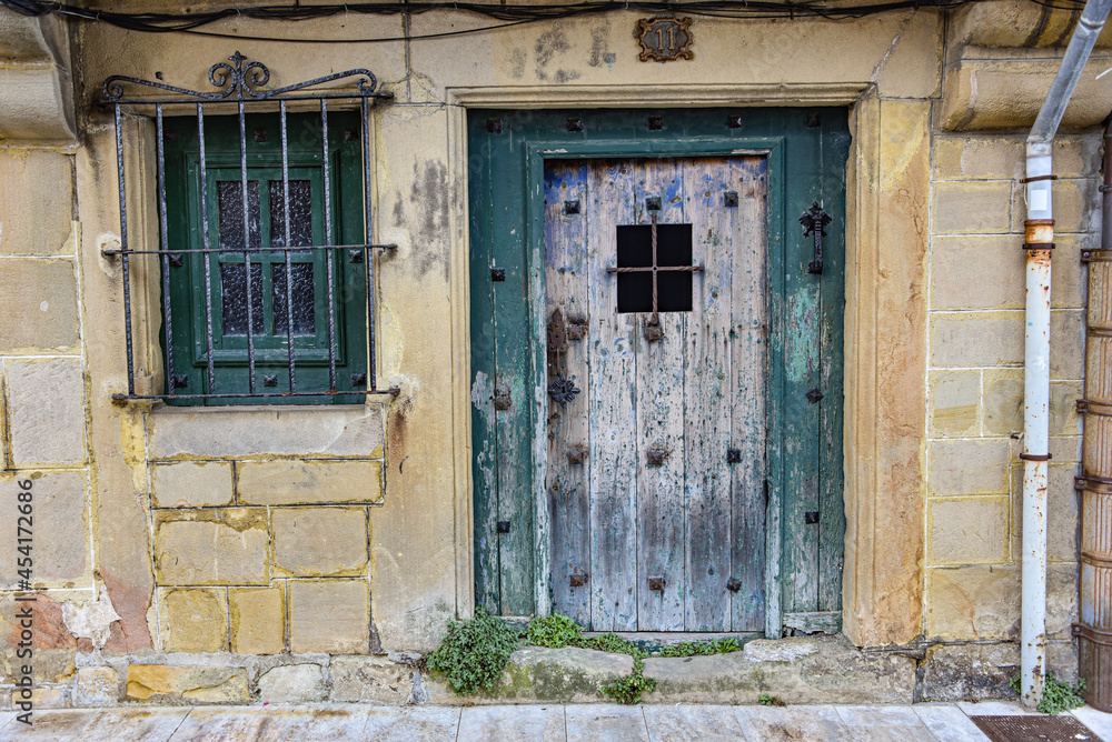 Hondarribia, Spain - 29 Aug 2021: An old wooden door on a traditional Basque home in old town Hondarribia