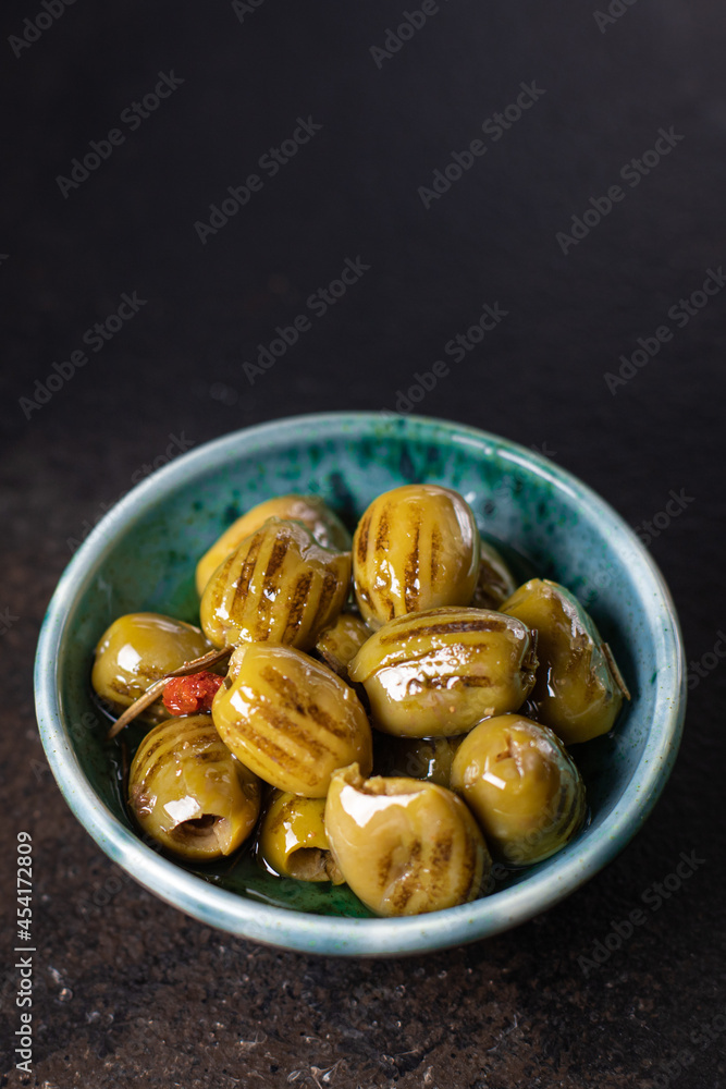 grilled olive fresh fruit olives in plate ready to eat meal snack on the table copy space food background rustic. top view keto or paleo diet veggie vegan or vegetarian food grilled olive fresh fruit olives in plate ready to eat meal snack on the table copy space food background rustic. top view keto or paleo diet veggie vegan or vegetarian food