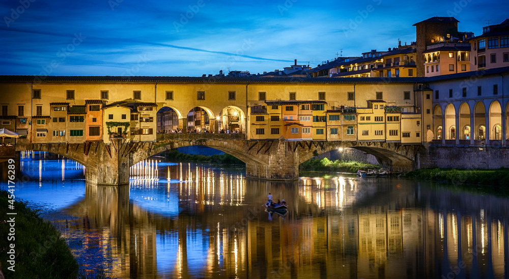 Evening view of the famous bridge Ponte Vecchio on the river Arno in Florence, Italy. The  Ponte Vechio bridge is one of the main attractions in Florence.