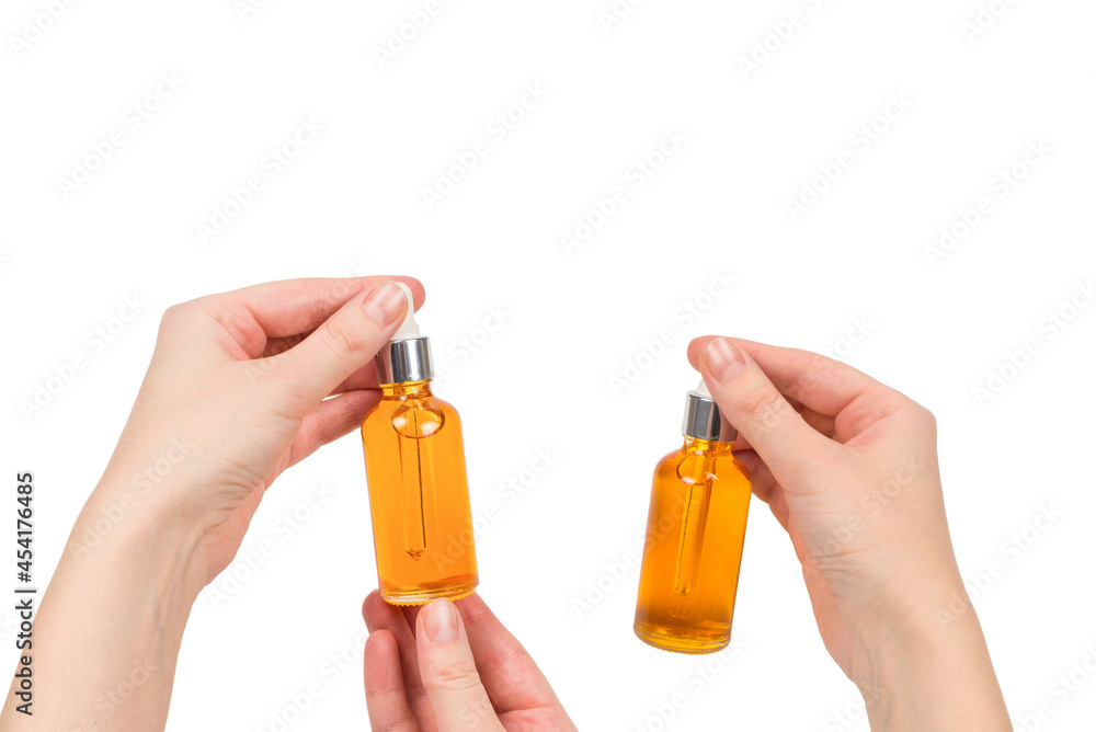 Bottle with oil in woman hand isolated on white. Bottle with oil in woman hand isolated on white.