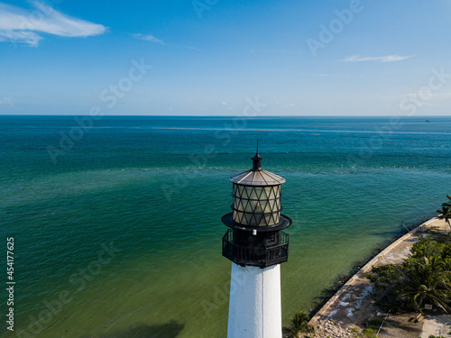 The restored Cape Florida Lighthouse on Biscayne Bay south of Miami Florida and the clear gorgeous waters and reefs