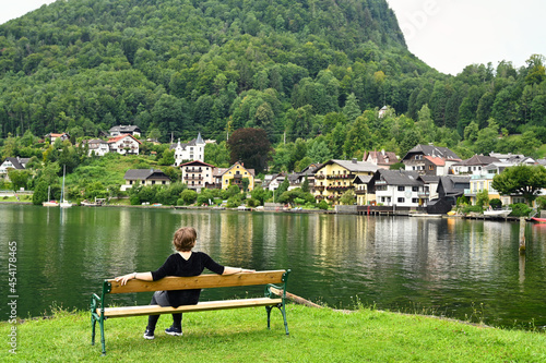 a girl sitting on a bench by the Lake Traun Traunsee in Upper Austria photo