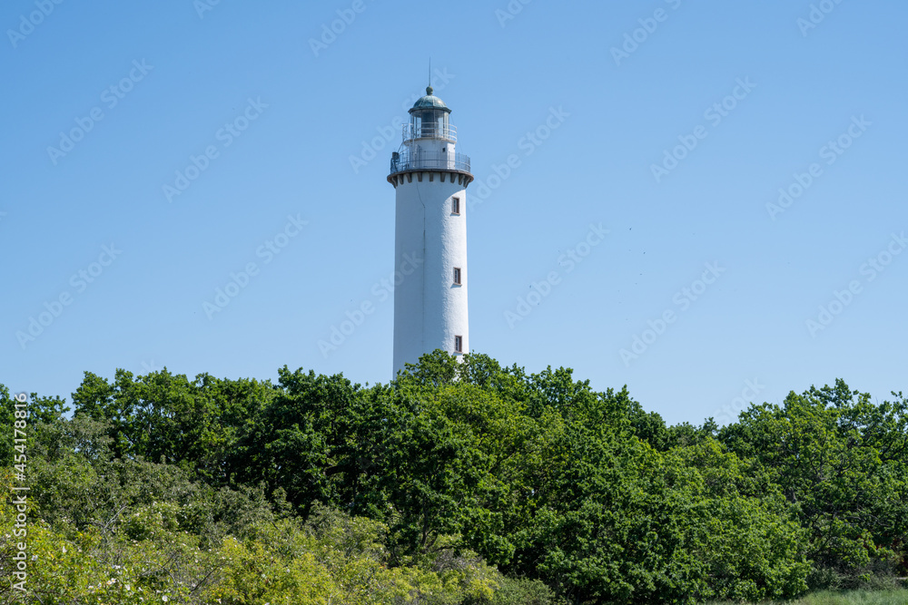The lighthouse Tall Erik at the northern tip of the Baltic Island of Oland. Blue sky in the background The lighthouse Tall Erik at the northern tip of the Baltic Island of Oland. Blue sky in the background