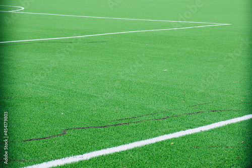 Fototapeta Naklejka Na Ścianę i Meble -  new soccer field, green turf and white dividing lines on the soccer field, corner and edge of the field, field markings