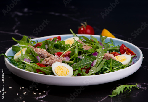 fresh salad with canned mackerel, arugula and tomatoes