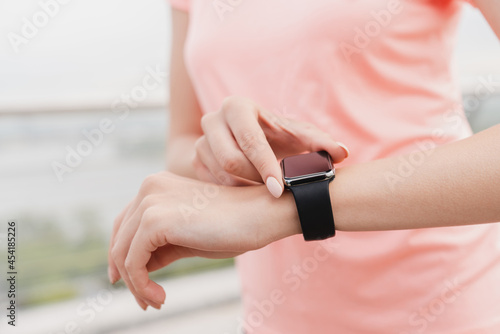 Close up cropped shot of a woman s wrist sport watch. Checking time concept. Technology and gadgets.