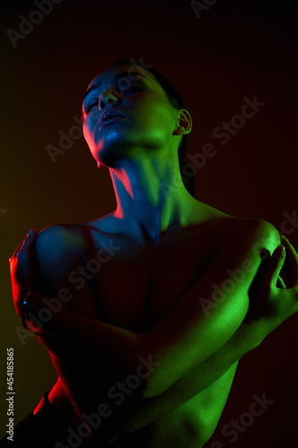 Female silhouette, beautiful woman in color lights