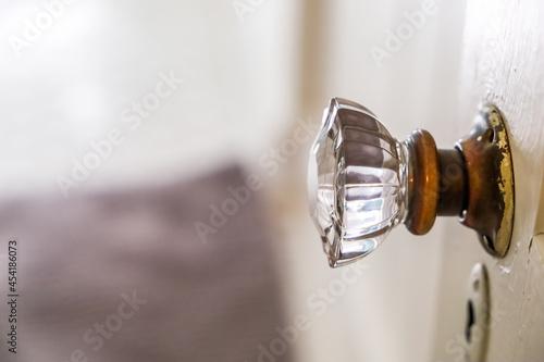Картината върху платно An antique vintage glass doorknob to a narrow bathroom in a small cottage house