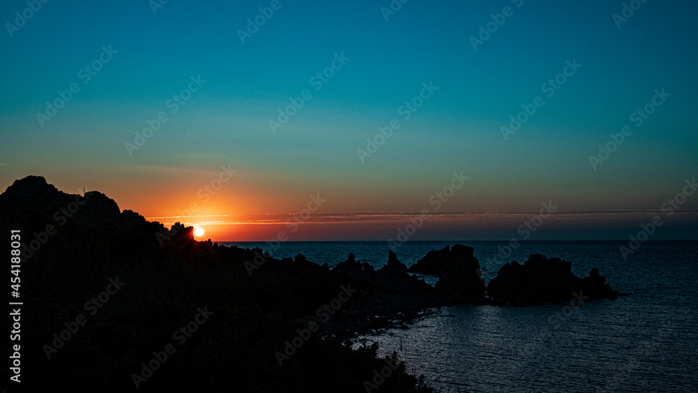 sunset view to the sea with coastline. Sardinia, Italy.