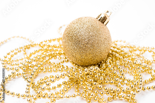 Christmas golden ball for Christmas tree decoration and holiday decorations on white background, close-up