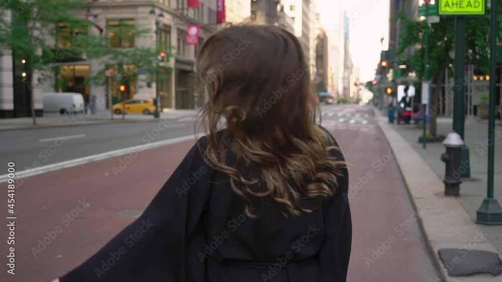 Girl in a black long dress runs through streets of Manhattan in New York. Girl in a black long dress runs through streets of Manhattan in New York.