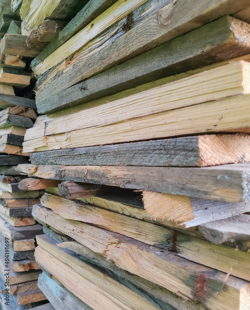 background from cut boards stacked in a pile. preparation of firewood for open fire background from cut boards stacked in a pile. preparation of firewood for open fire
