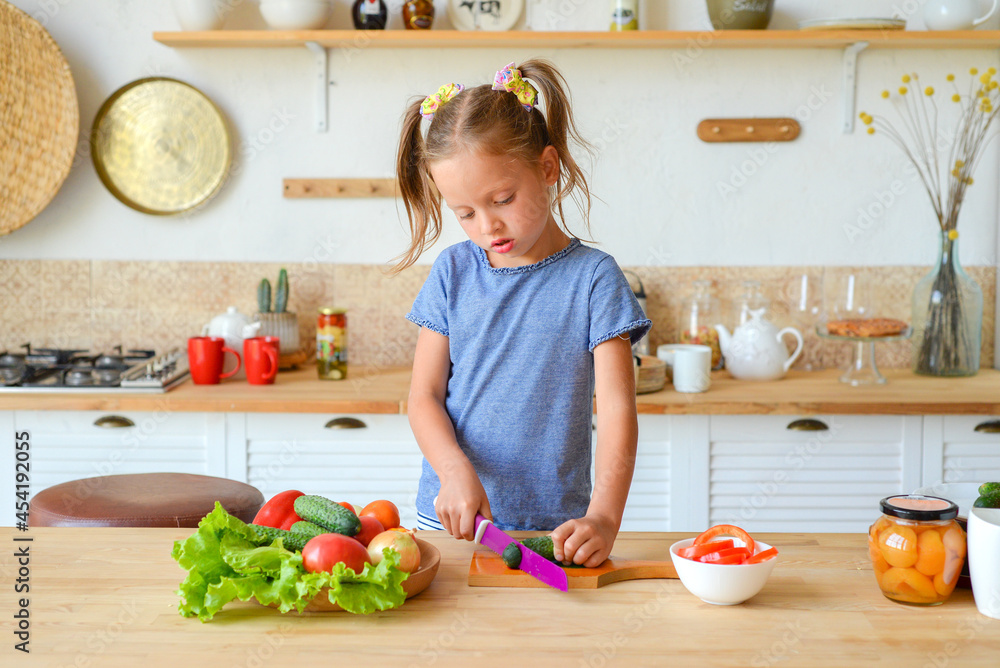 portrait of a little cute girl in the kitchen with groceries and healthy food portrait of a little cute girl in the kitchen with groceries and healthy food