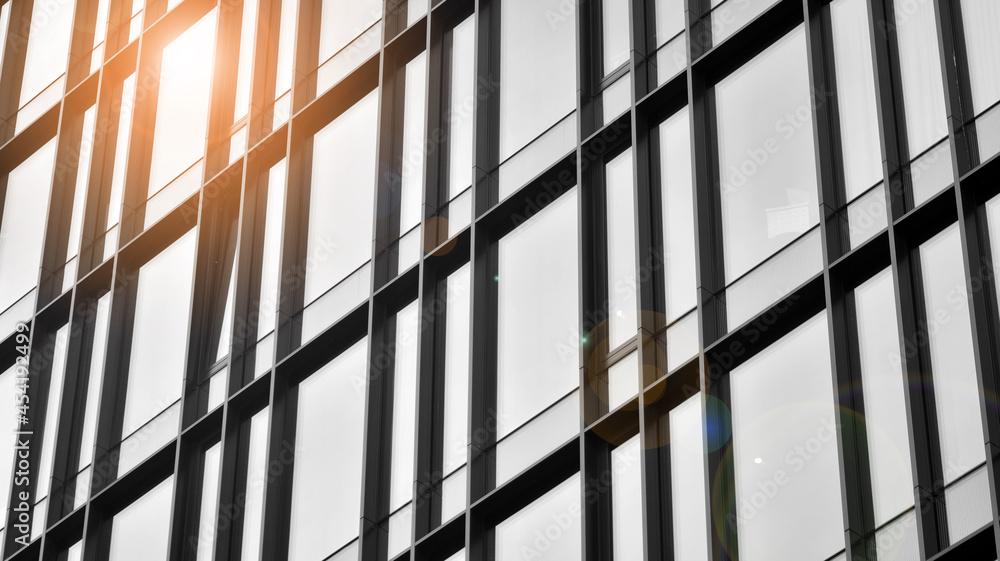 custom made wallpaper toronto digitalModern architectural details. Modern glass facade with a geometric pattern. Contemporary corporate business architecture. Red sun on horizon. Black and white toned image.