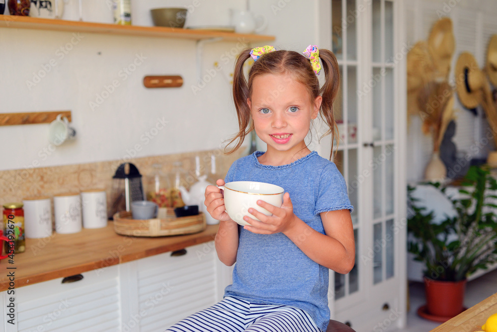 portrait of a little cute girl in the kitchen with groceries and healthy food portrait of a little cute girl in the kitchen with groceries and healthy food