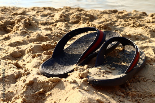 Flip flops on a sandy beach. Summer vacation concept