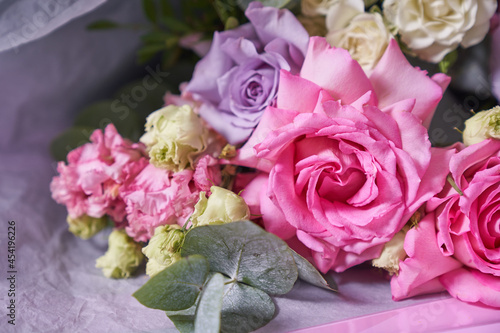 Close-up of a colorful bouquet of flowers. Big pink roses. On a light background  top view  copy space. High quality photo