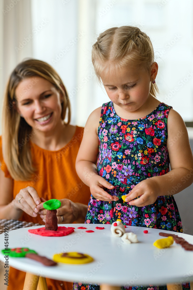 Fototapeta premium Happy children and women having fun time and playing together. Family, kindergarten, kids concept