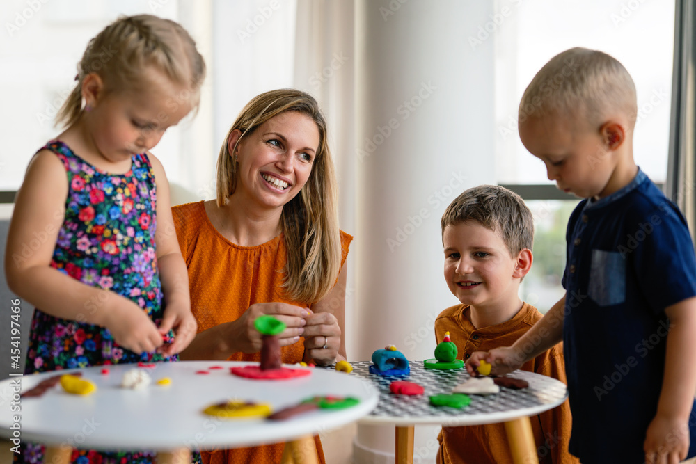 Family activities in the kids room. Woman and children playing together. Family activities in the kids room. Woman and children playing together.