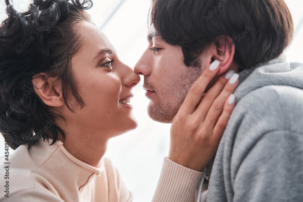 Girl looking at her boyfriend while preparing to the kiss Girl looking at her boyfriend while preparing to the kiss