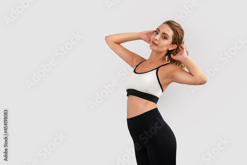 Sportive young woman, stretching her body for exercising in gym. Sport and healthy body © Sondem