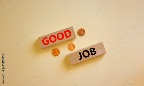 Good job symbol. Concept words 'good job' on wooden blocks on a beautiful white background, metallic coins. Business and good job concept, copy space.