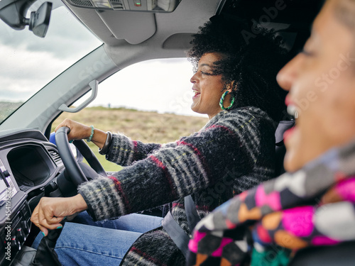 Smiling women traveling by car