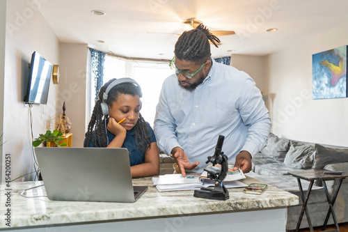 Father helping daughter do homework