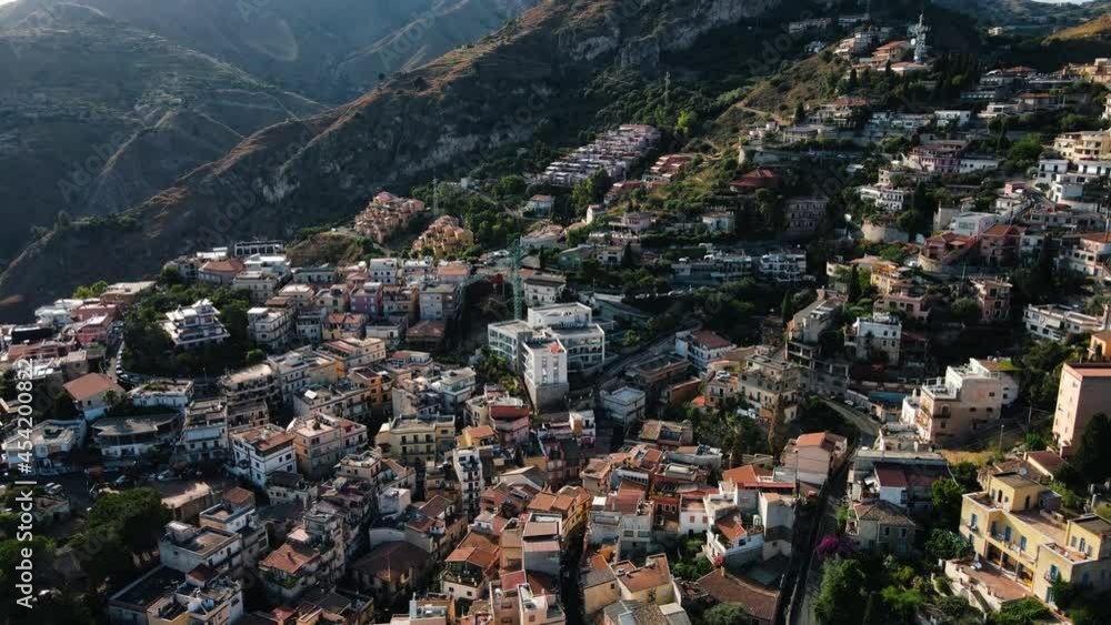 Taormina, Sicily, Italy - drone shot of the cityscape while sunset.