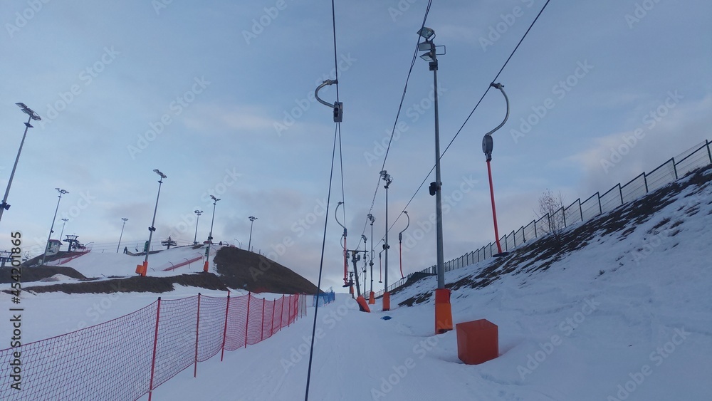 The ski center has a rope lift, and the slopes are equipped with a mesh fence and poles with lighting lamps. The ski center has a rope lift, and the slopes are equipped with a mesh fence and poles with lighting lamps.