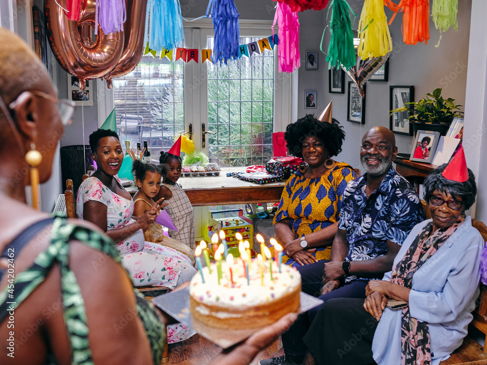 Fototapeta premium Multi-generation family celebrating birthday with birthday cake