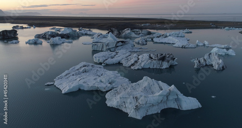 Icebergs in famous jokulsarlon glacial lake, Aerial Drone view above Icebergs and bridge jokulsarlon lagoon lake, February 2021 