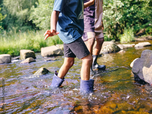 Fotobehang UK, Children wading in shallow creek