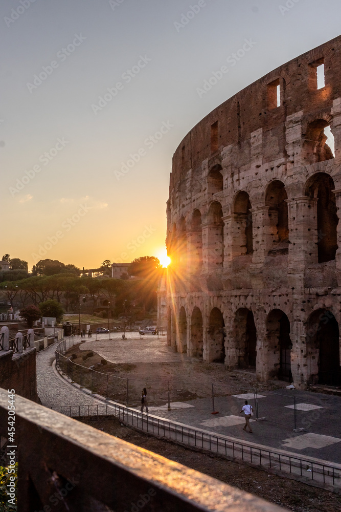 famous architecture ancient colosseum at sunset, Italy
