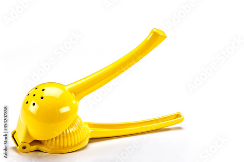 Manual yellow lemon squeezer isolated on white background. Horizontal view of lemon squeezer