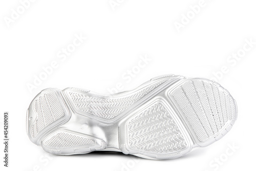 White and black leather sneakers. Casual women's style. White rubber soles. Isolated close-up on white background. Shoe sole view. Fashion shoes.