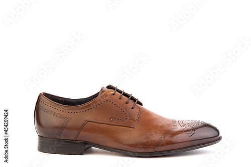 A classic leather elegant brogues men's shoes isolated white background. Groom's stylish brown shoes. Isolated object close up on white background. Right shoe view. © MONIUK ANDRII