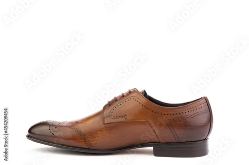 A classic leather elegant brogues men's shoes isolated white background. Groom's stylish brown shoes. Isolated object close up on white background. Left shoe view.