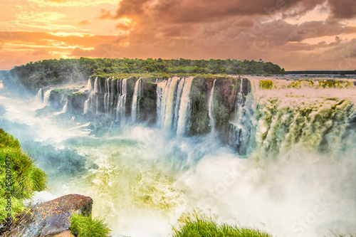 Shot of Iguazu Falls between Argentina and Brazil in the background of the sunset. photo