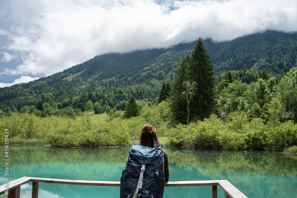 Fototapeta premium Female hiker resting by a beautiful lake