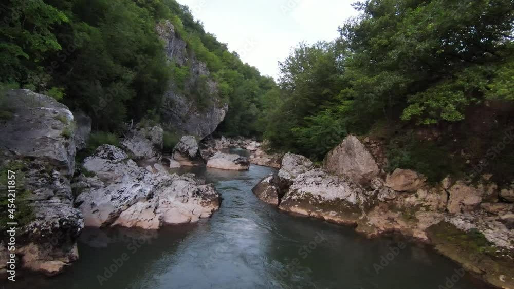 FPV Aerial shot dynamic flying at natural landscape river canyon in the dense green forest and rapid movement. Shooting from fpv helicopter low key scenery. FPV Aerial shot dynamic flying at natural landscape river canyon in the dense green forest and rapid movement. Shooting from fpv helicopter low key scenery.