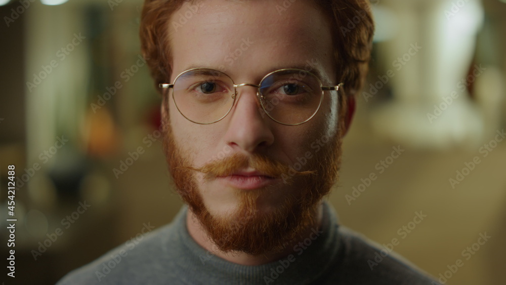 Male IT specialist posing at camera in office. Serious businessman face Male IT specialist posing at camera in office. Serious businessman face