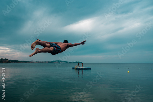 person jumping into the sea