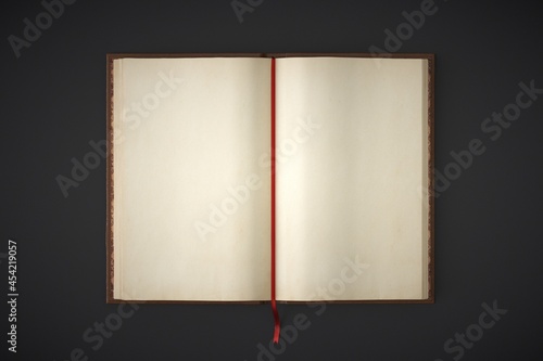 Photos Blank open hardcover book on dark background.