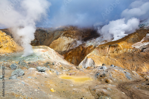Beautiful volcanic landscape, crater of active volcano: hot spring, fumarole, lava field, gas-steam activity. Mountain landscape, travel destinations for active vacation, hiking and mount climbing